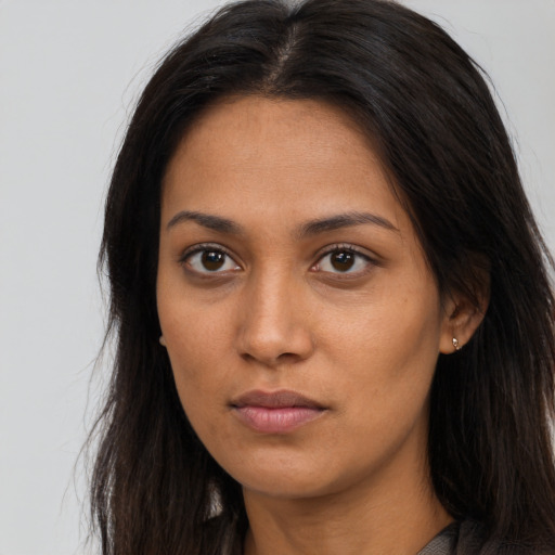 Neutral latino young-adult female with long  brown hair and brown eyes
