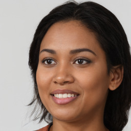 Joyful latino young-adult female with medium  black hair and brown eyes