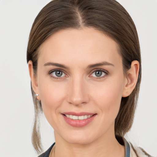 Joyful white young-adult female with medium  brown hair and grey eyes