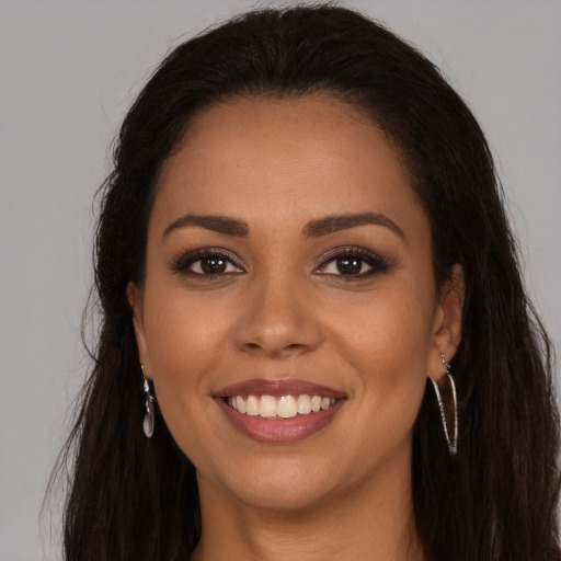 Joyful latino young-adult female with long  brown hair and brown eyes