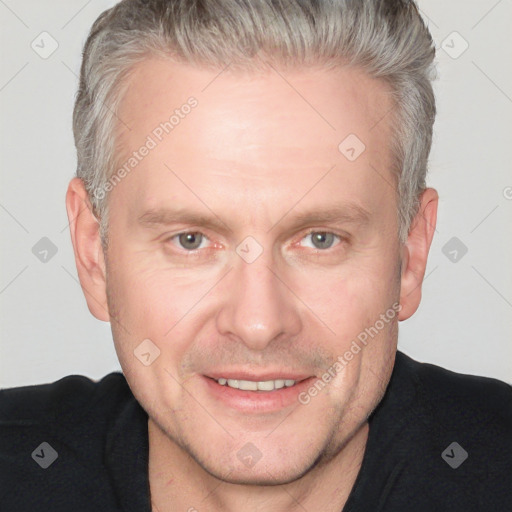 Joyful white adult male with short  brown hair and grey eyes