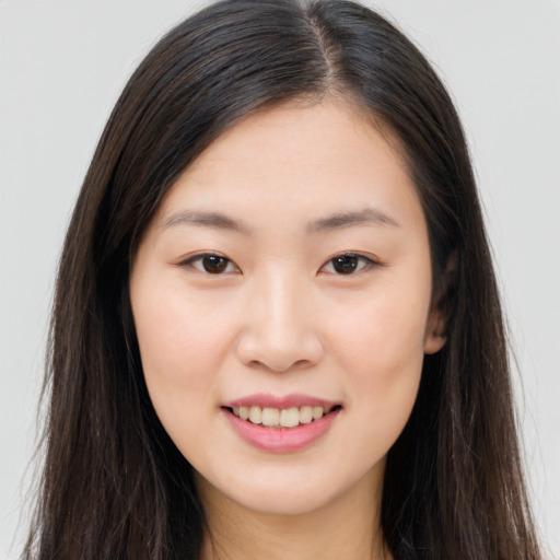 Joyful asian young-adult female with long  brown hair and brown eyes
