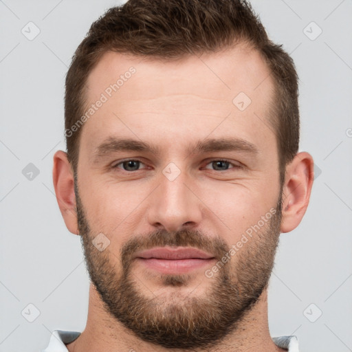 Joyful white young-adult male with short  brown hair and grey eyes