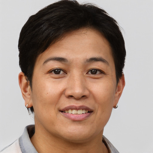 Joyful asian adult female with short  brown hair and brown eyes