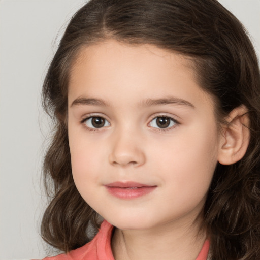 Joyful white child female with medium  brown hair and brown eyes