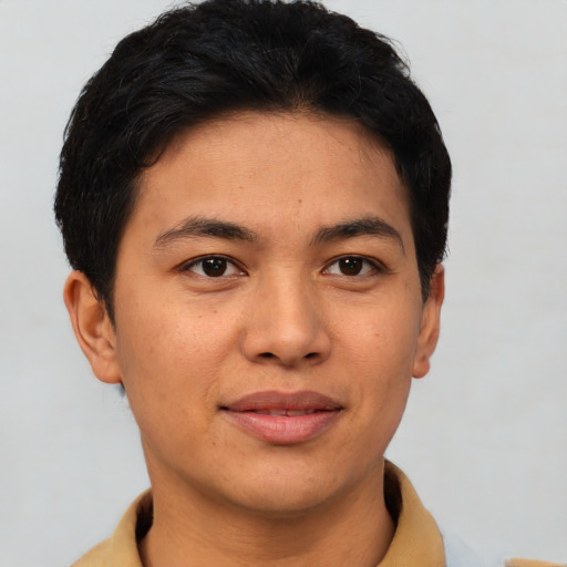 Joyful asian young-adult male with short  brown hair and brown eyes