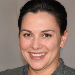 Joyful white adult female with short  brown hair and brown eyes