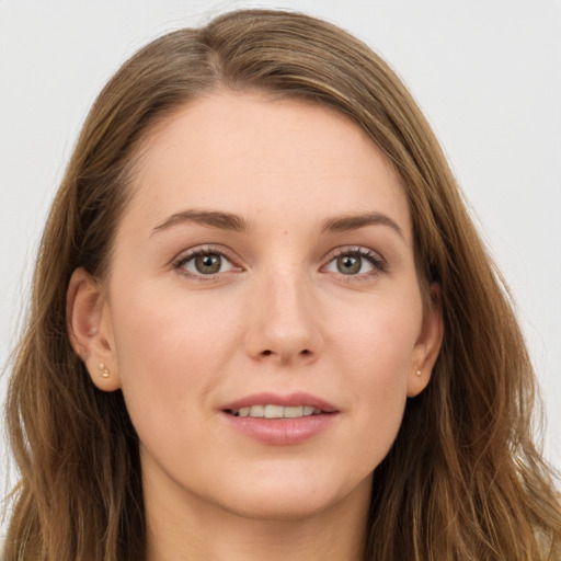 Joyful white young-adult female with long  brown hair and grey eyes