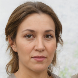 Joyful white adult female with medium  brown hair and brown eyes