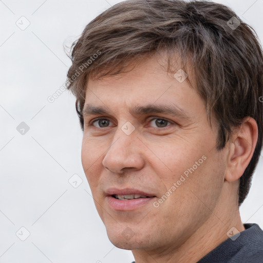 Joyful white adult male with short  brown hair and brown eyes