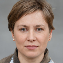 Joyful white adult female with short  brown hair and grey eyes