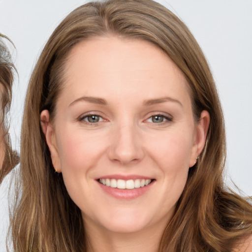 Joyful white young-adult female with long  brown hair and brown eyes