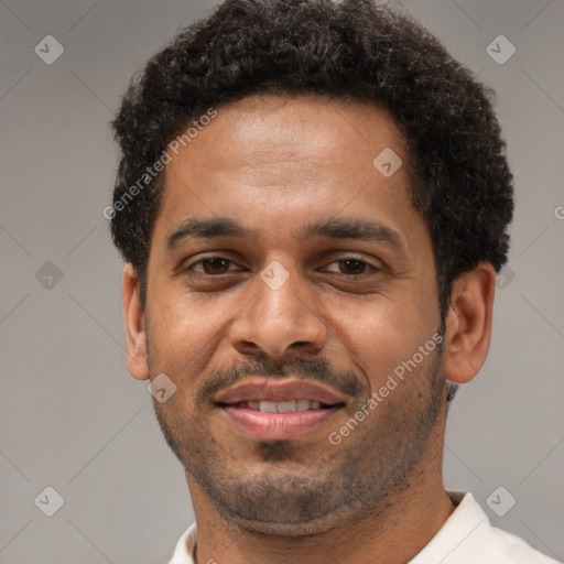 Joyful latino adult male with short  black hair and brown eyes