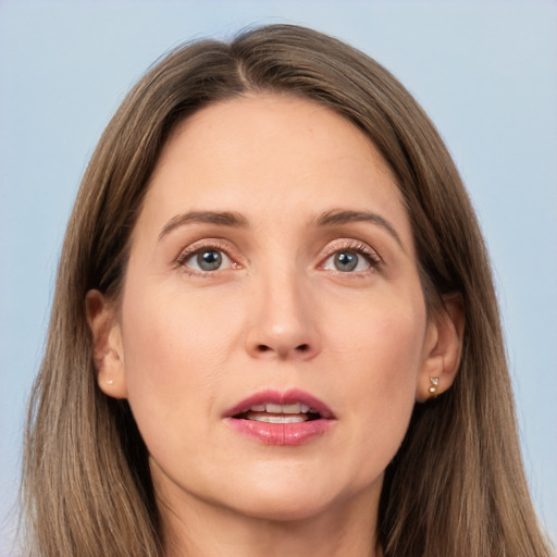 Joyful white adult female with long  brown hair and grey eyes