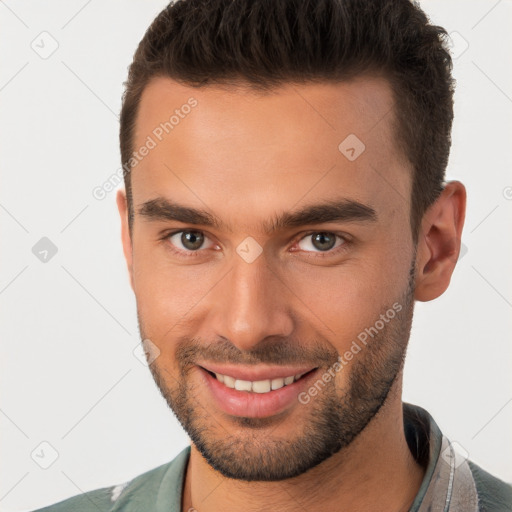 Joyful white young-adult male with short  brown hair and brown eyes