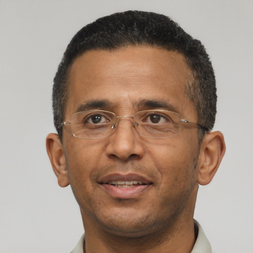 Joyful black adult male with short  brown hair and brown eyes