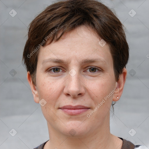 Joyful white adult female with short  brown hair and grey eyes