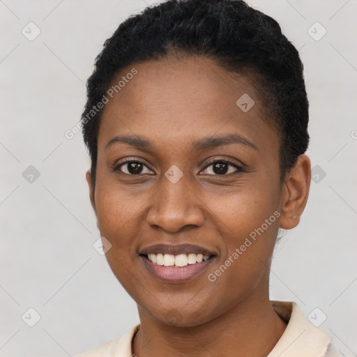 Joyful black young-adult female with short  black hair and brown eyes