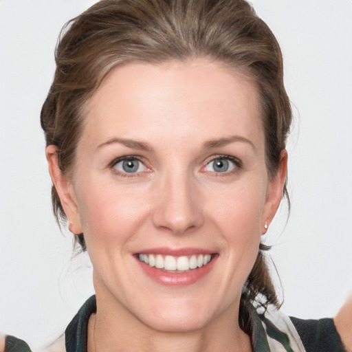 Joyful white young-adult female with medium  brown hair and blue eyes