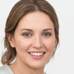 Joyful white young-adult female with medium  brown hair and green eyes