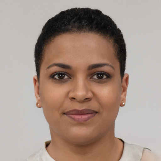 Joyful black young-adult female with short  brown hair and brown eyes