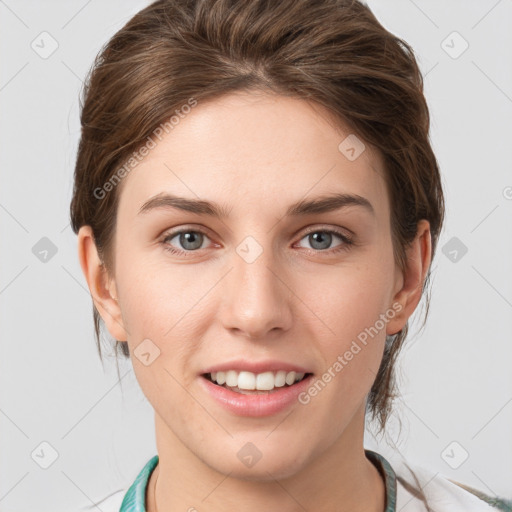 Joyful white young-adult female with medium  brown hair and grey eyes