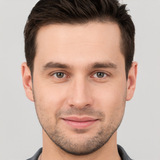 Joyful white young-adult male with short  brown hair and brown eyes