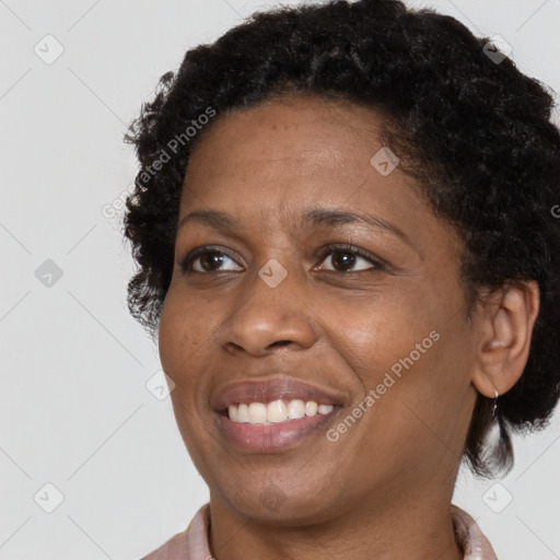 Joyful black adult female with short  brown hair and brown eyes