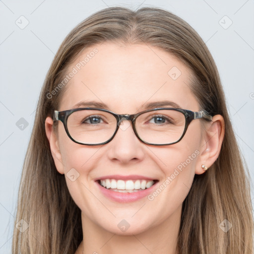 Joyful white young-adult female with long  brown hair and blue eyes