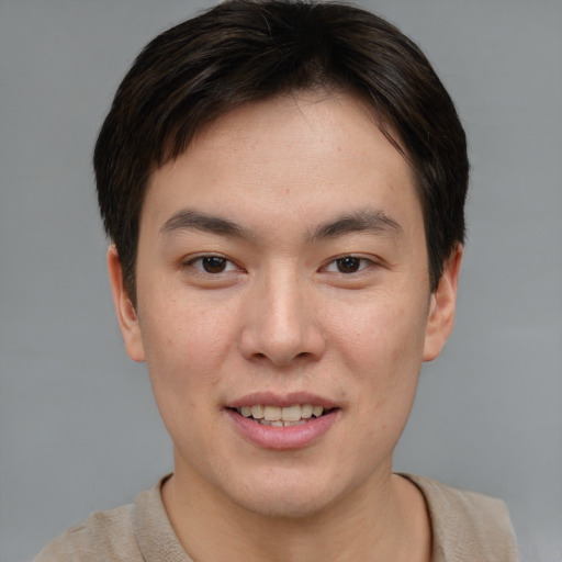 Joyful asian young-adult male with short  brown hair and brown eyes