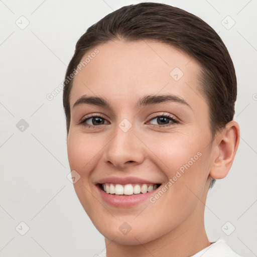 Joyful white young-adult female with short  brown hair and brown eyes