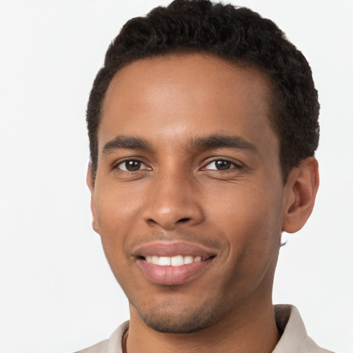 Joyful black young-adult male with short  brown hair and brown eyes