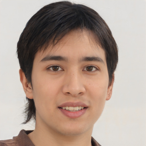 Joyful asian young-adult male with short  brown hair and brown eyes