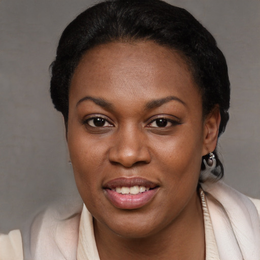 Joyful black young-adult female with short  brown hair and brown eyes