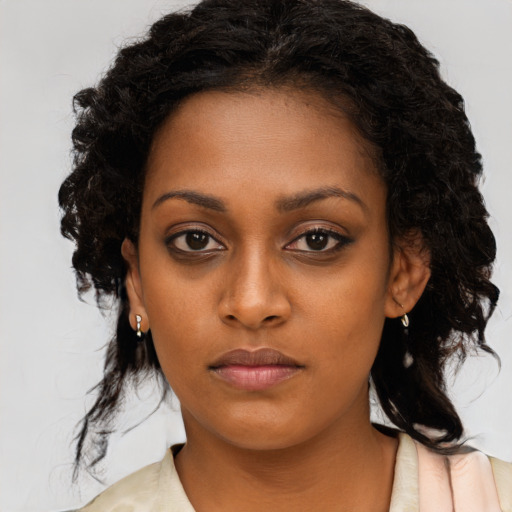 Neutral black young-adult female with medium  brown hair and brown eyes