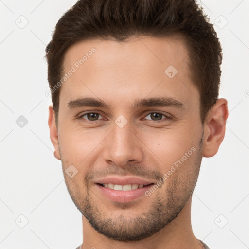 Joyful white young-adult male with short  brown hair and brown eyes