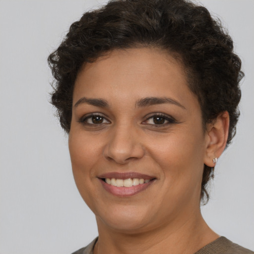 Joyful latino young-adult female with short  brown hair and brown eyes