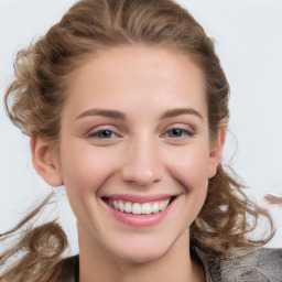 Joyful white young-adult female with medium  brown hair and blue eyes