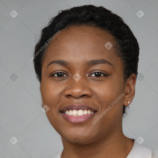 Joyful black young-adult female with short  black hair and brown eyes