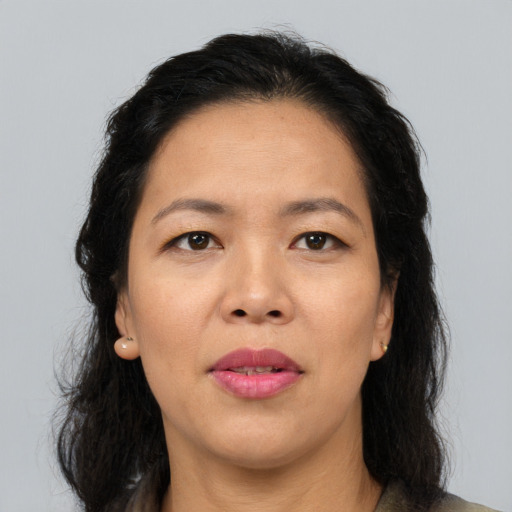 Joyful asian adult female with long  brown hair and brown eyes
