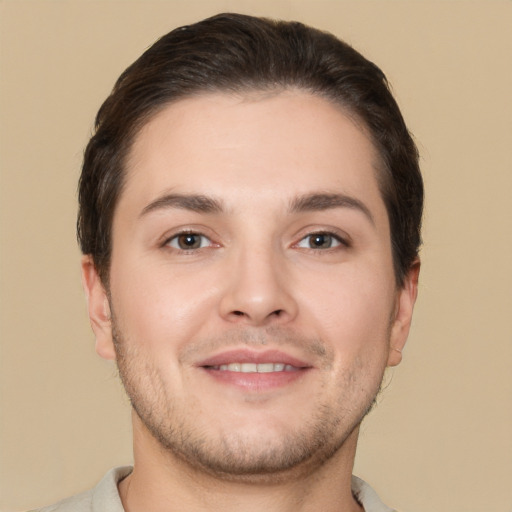 Joyful white young-adult male with short  brown hair and brown eyes