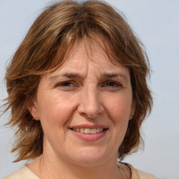 Joyful white adult female with medium  brown hair and brown eyes