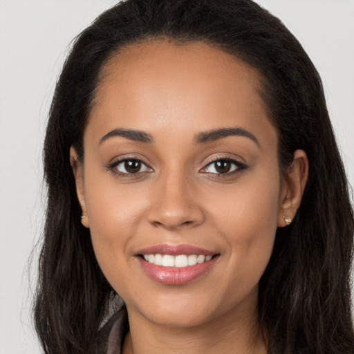 Joyful white young-adult female with long  brown hair and brown eyes