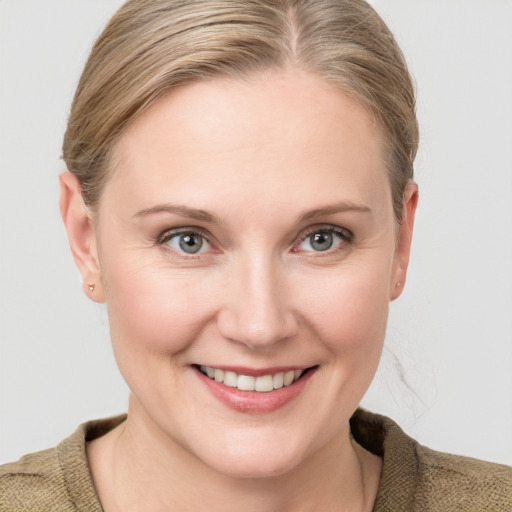 Joyful white young-adult female with medium  brown hair and blue eyes