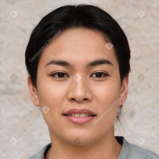 Joyful asian young-adult female with short  black hair and brown eyes