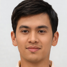 Joyful latino young-adult male with short  brown hair and brown eyes