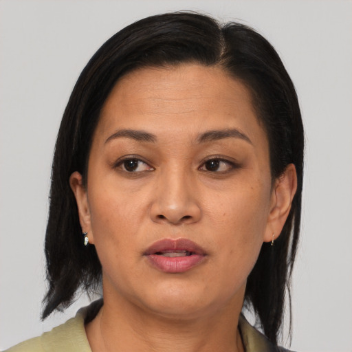 Joyful asian adult female with medium  brown hair and brown eyes