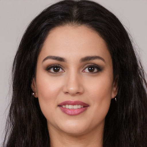 Joyful white young-adult female with long  brown hair and brown eyes