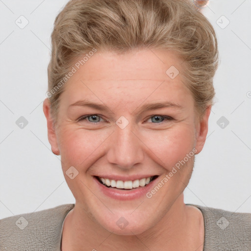 Joyful white young-adult female with short  brown hair and blue eyes