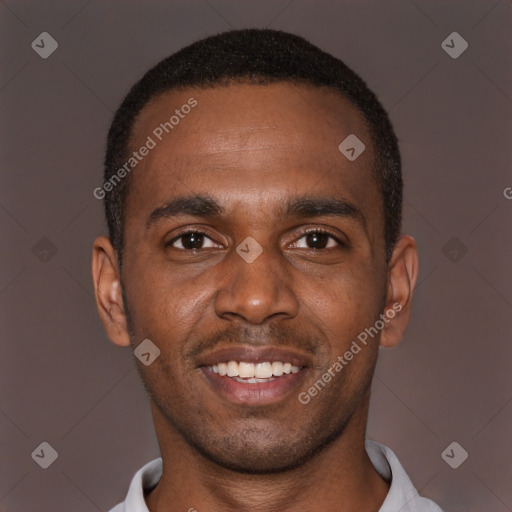 Joyful black young-adult male with short  brown hair and brown eyes
